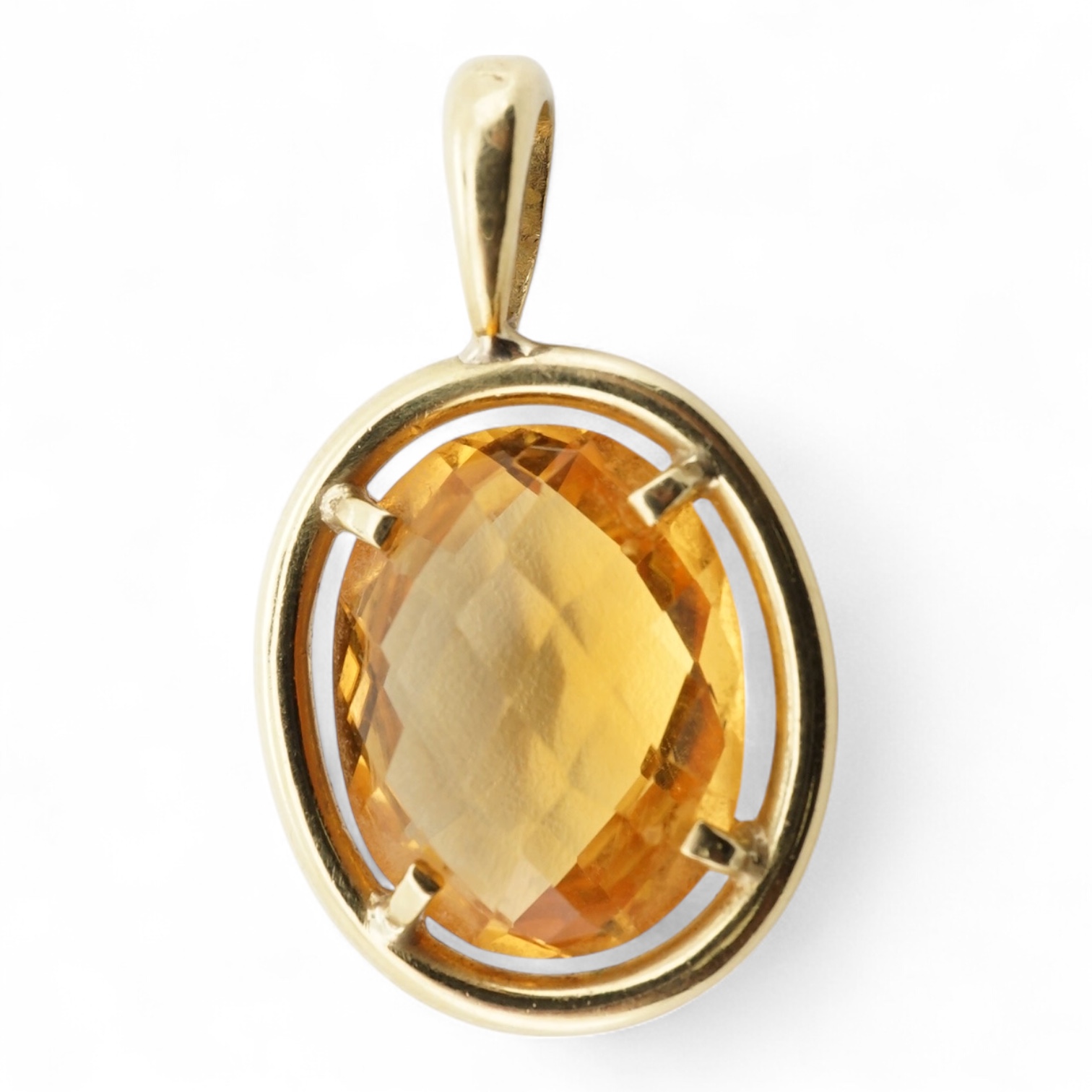 A modern yellow metal (stamped 750) and facet cut oval citrine set pendant, overall 27mm, gross weight 4.9 grams.